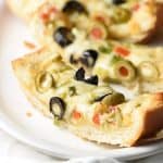 This Olive Cheese Bread is an easy and delicious appetizer with salty olives, gooey cheese, and crunchy bread. Crazy good!