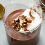 chocolate pudding in cup with whipped cream and chocolate shavings