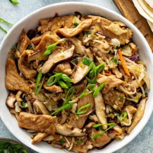 Moo shu pork stir fry in white serving bowl