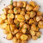 overhead pile of oven roasted potatoes on white plate