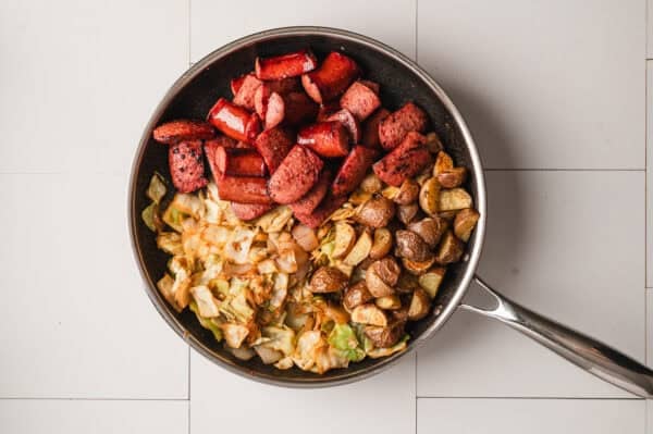 overhead fried kielbasa, cabbage, and potatoes in skillet