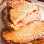 A half of a Monte Cristo grilled cheese on top of another one