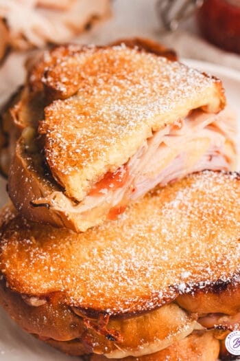 A half of a Monte Cristo grilled cheese on top of another one